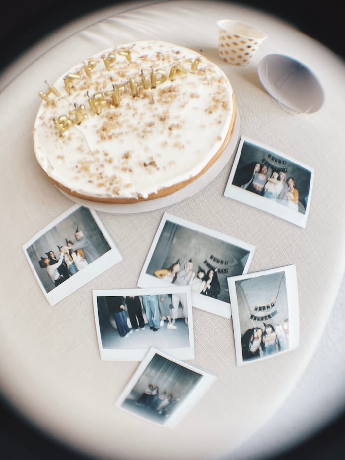A fisheye view of a birthday cake surrounded by photos, capturing festive moments.